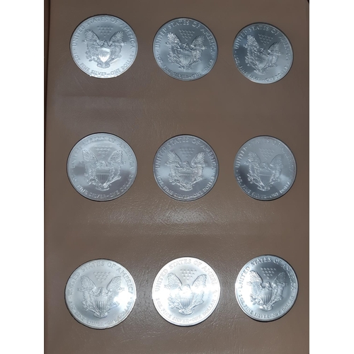 138 - A Dansco Archival slipcased coin album containing 32 american eagle silver dollars ranging from 1986... 