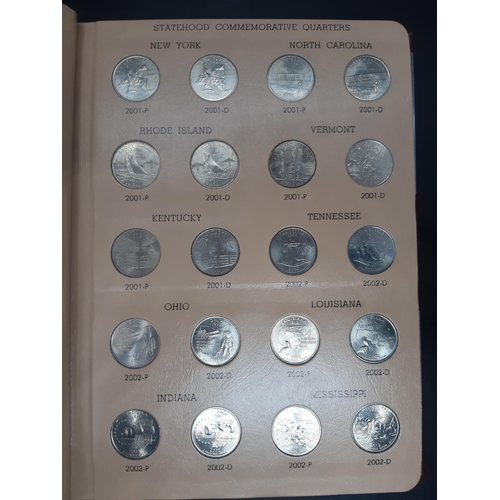 139 - A Dansco Archival slipcased coin album containing 100 Statehood commemorative quarters to include De... 