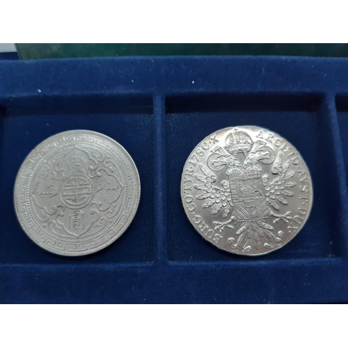 142 - A Westminster Coin Collection coin case containing 12 coins to include a silver Maria Theresia Thale... 