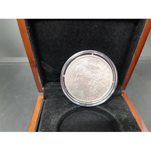 143 - A cased silver 1921 US Morgan dollar designed by George T Morgan and produced at the Denver Mint