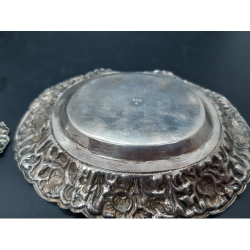 78 - Two items to include a hallmarked 800 grade silver trinket dish with repousse floral design and a sm... 