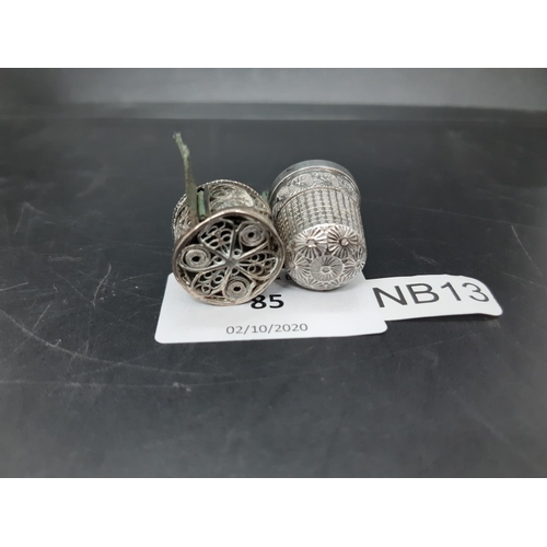 85 - Two items to include a hallmarked Birmingham silver thimble and a white metal filigree tape measure ... 