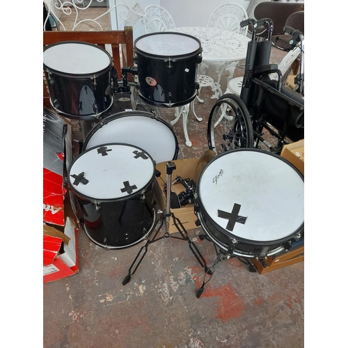 682 - An incomplete black and white Stagg five piece drum kit comprising of bass drum with foot pedal, two... 