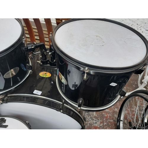 682 - An incomplete black and white Stagg five piece drum kit comprising of bass drum with foot pedal, two... 