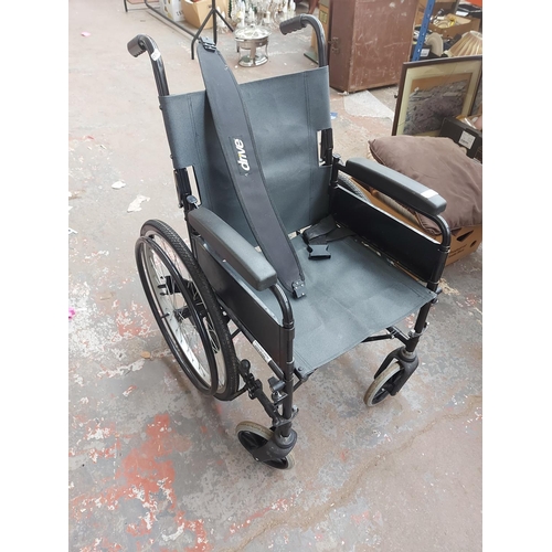 683 - Two items of mobility equipment to include a NRS black four wheeled walking aid with brakes and a bl... 