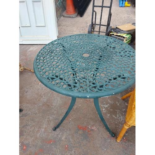 689 - Seven items to include two green circular cast aluminium patio tables with three chairs, garden sunl... 