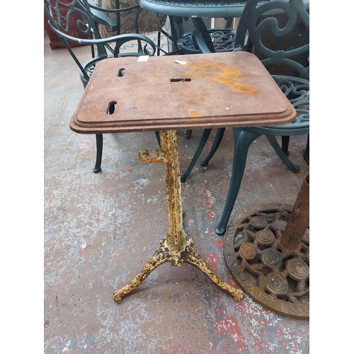 690 - A vintage cast iron high work stool on ornate supports