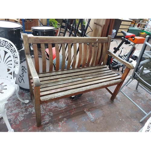 700 - A wooden slatted two seat garden bench