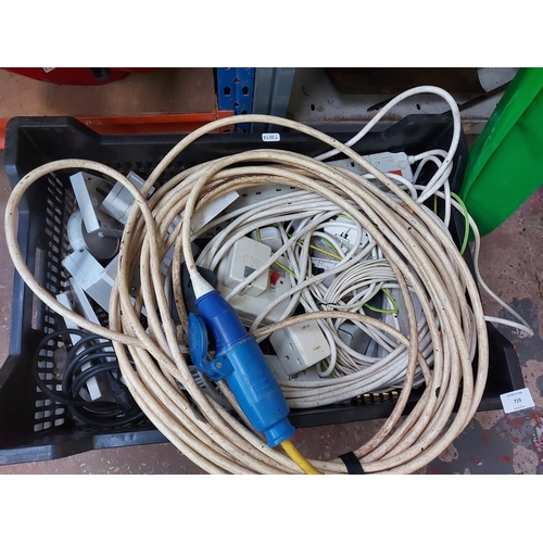 719 - A box containing electrical items to include caravan hook up lead, plug sockets, multi plugs, variou... 