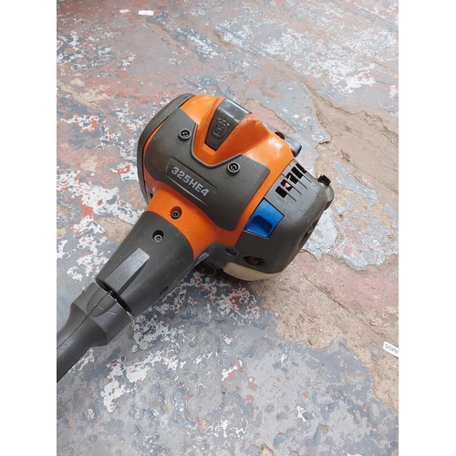 720 - A grey and orange Husqvarna 325HE4 long reach petrol hedge trimmer with 20