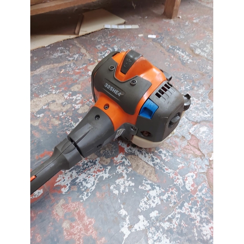 721 - A grey and orange Husqvarna 325HE4 long reach petrol hedge trimmer with 20