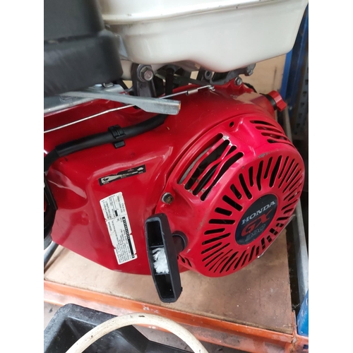 728 - Two items to include a red Honda GX390 complete petrol engine together with a Solo rucksack pressure... 