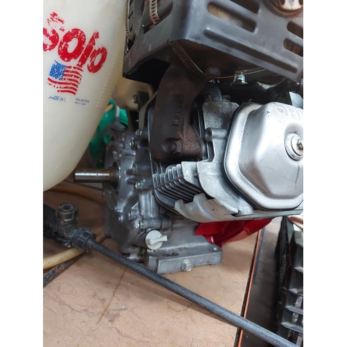 728 - Two items to include a red Honda GX390 complete petrol engine together with a Solo rucksack pressure... 