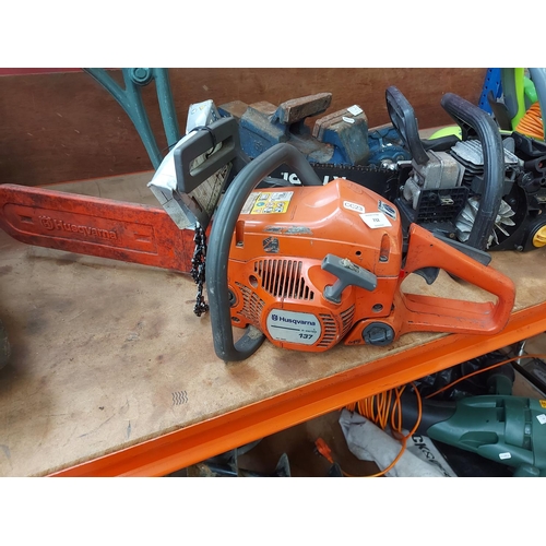 732 - An orange and grey Husqvarna 137 petrol chainsaw with 15