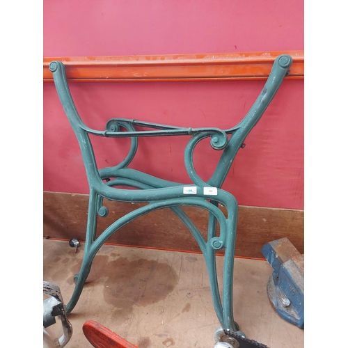 733 - A pair of green painted cast iron garden bench ends