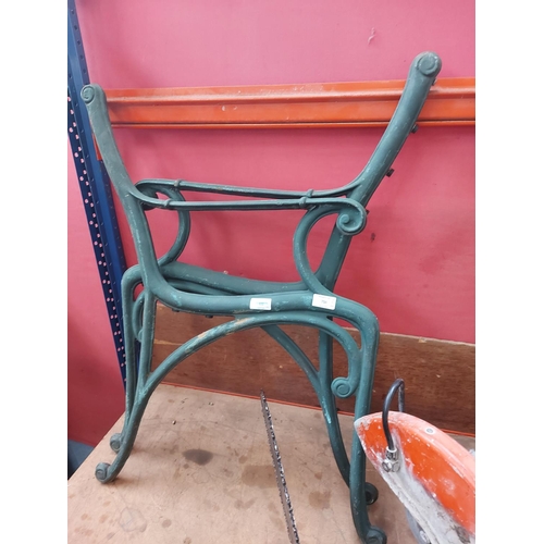 734 - A pair of green painted cast iron garden bench ends