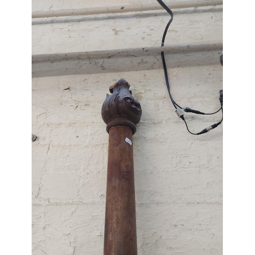 776 - A large ornate wooden curtain pole measuring approx. 2.5m x 7cm diameter