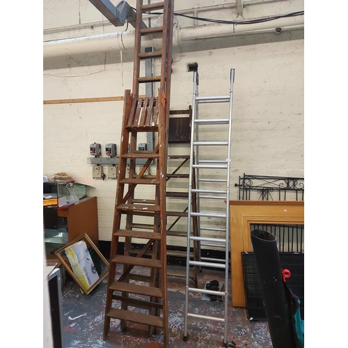 782 - Two vintage items to include wooden 8 tread step ladders and a Lion double extendable 30 rung wooden... 