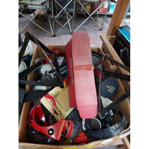 830 - A mixed lot to include car axle stands, welding goggles, mastic gun, various paints etc.