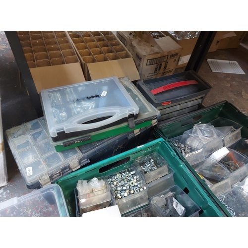 857 - A mixed lot of toolboxes, cases and boxes containing nuts, bolts, pot rivets, tools, wall fixings et... 