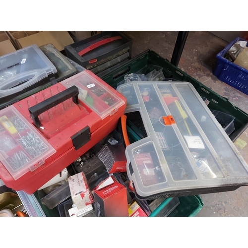 857 - A mixed lot of toolboxes, cases and boxes containing nuts, bolts, pot rivets, tools, wall fixings et... 