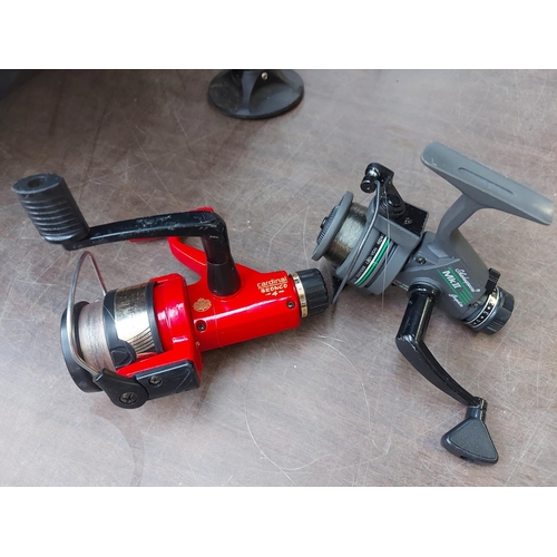 893 - Four various fishing reels to include Shakespeare MG1000 and Mark 2, Abu Garcia Cardinal and JW 200