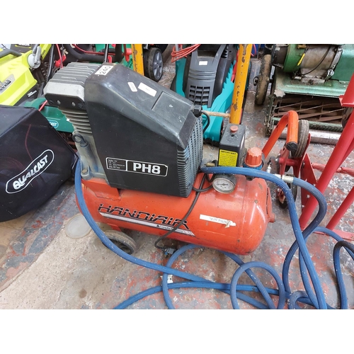 915 - Two items to include a black and red Handiair air compressor with hose and a black and orange two wh... 