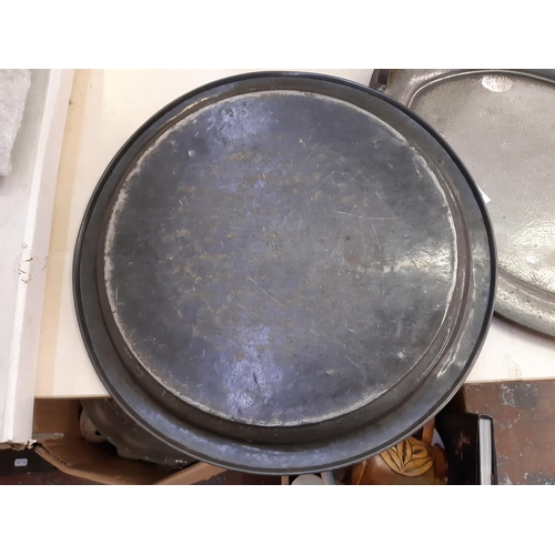 152 - Two Arts & Crafts hammered pewter trays to include a W & Co twin handled example and a circular Tudr... 