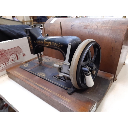 162 - A vintage cased Gamages sewing machine