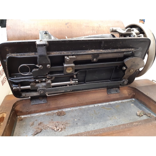 162 - A vintage cased Gamages sewing machine