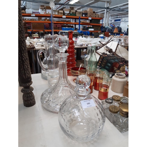 165 - A collection of various items to include a good quality cut glass ship decanter, cut glass spherical... 