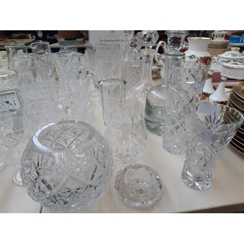 212 - A large collection of good quality glassware and cut crystal to include four decanters, spherical bo... 