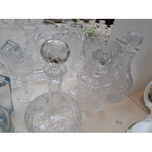 212 - A large collection of good quality glassware and cut crystal to include four decanters, spherical bo... 