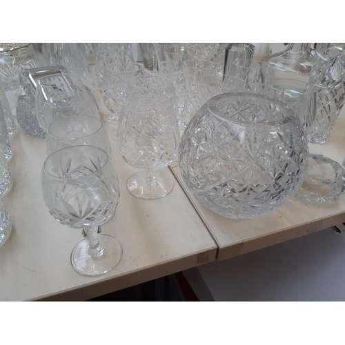 212 - A large collection of good quality glassware and cut crystal to include four decanters, spherical bo... 