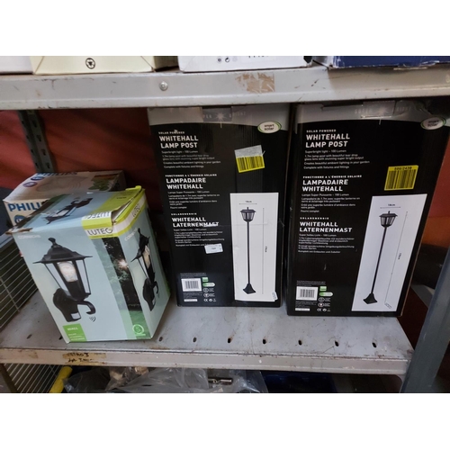 764 - Four boxed shop return items to include two solar powered Whitehall lamp post lights, a Lutec outdoo... 