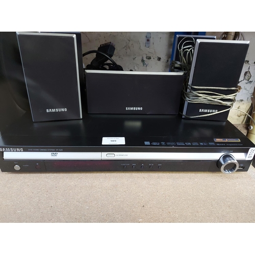 989 - A Samsung 5.1 home cinema system comprising HTQ20 DVD amp, front, centre and rear sub woofer speaker... 