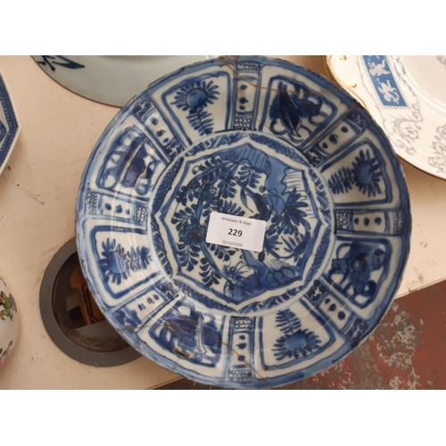 229 - A collection of 19th/20th century oriental ceramics to include a blue and white shallow dish with fl... 