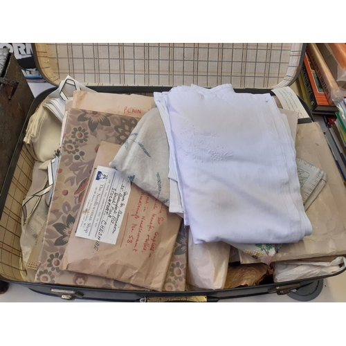 251 - A suitcase containing a large quantity of vintage linen together with various fabric patterns and se... 