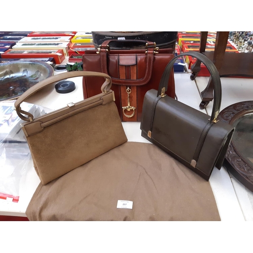 257 - Three good quality ladies handbags to include a Loewe green leather bag, Loewe suede bag and a Cavan... 