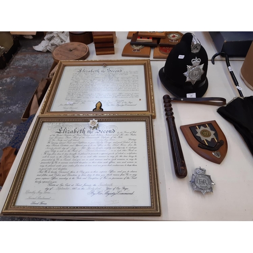 266 - A collection of police ephemera to include a vintage turned wooden truncheon, Cheshire Constabulary ... 