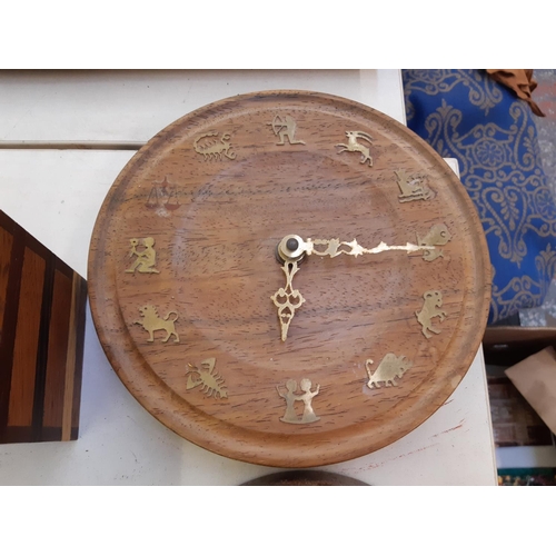 267 - Four pieces of treenware to include circular wall clock and three various lidded boxes