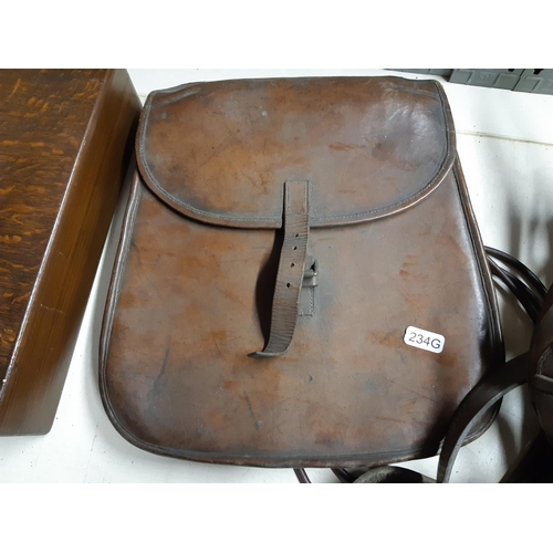 297 - A quantity of vintage horse tack to include brown leather saddle bags, stirrups etc.