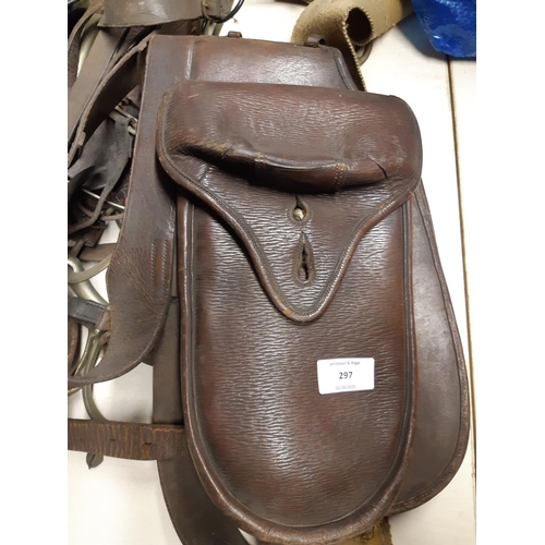 297 - A quantity of vintage horse tack to include brown leather saddle bags, stirrups etc.