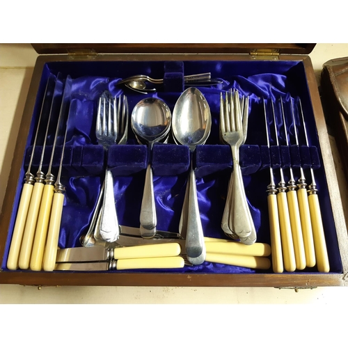 298 - An oak cased part canteen of cutlery with brass cartouche