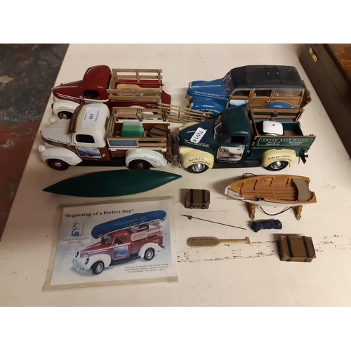 299 - Four American Ertl model pickups on mahogany display stand to include a 1947 Dodge, two 1940s Fords ... 