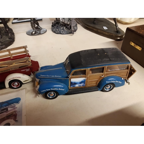 299 - Four American Ertl model pickups on mahogany display stand to include a 1947 Dodge, two 1940s Fords ... 