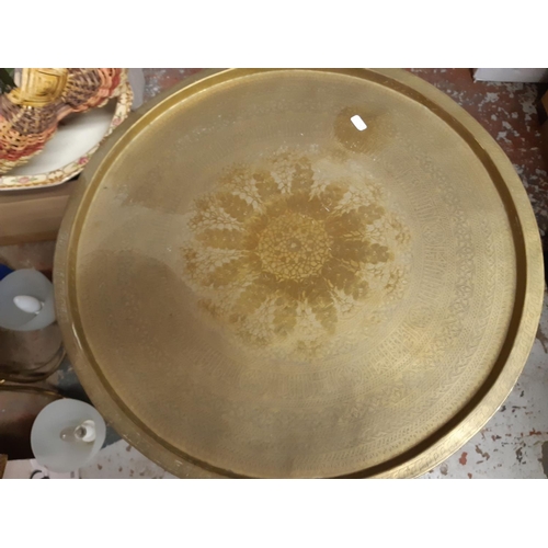 315 - A Middle Eastern folding travel table with well detailed etched brass charger top - measuring approx... 