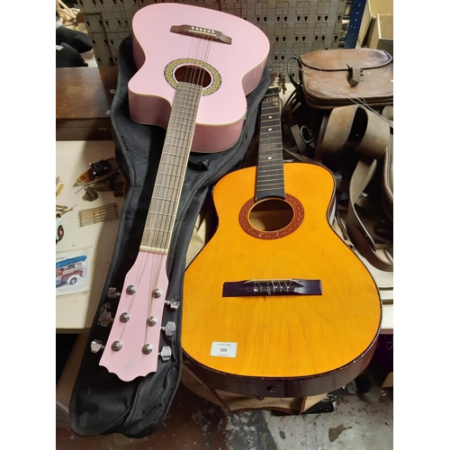 320 - Two child's acoustic guitar to include one pink (see condition report)