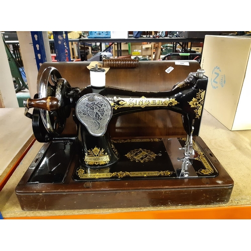 334 - A vintage mahogany cased Singer hand crank sewing machine - Serial No. Y9855402