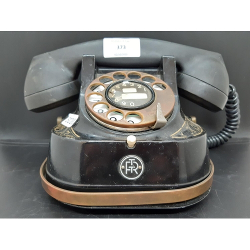 373 - A vintage Bell black bakelite MFG dial up telephone with gilt decorative design